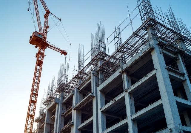Modern construction site with heavy machinery and steel beams